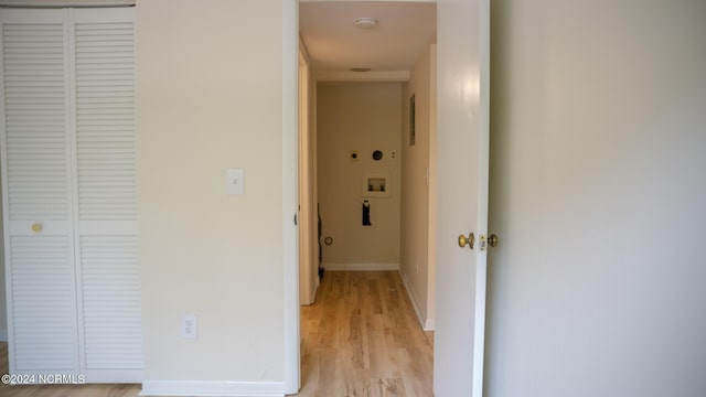 hallway with light wood-style flooring and baseboards