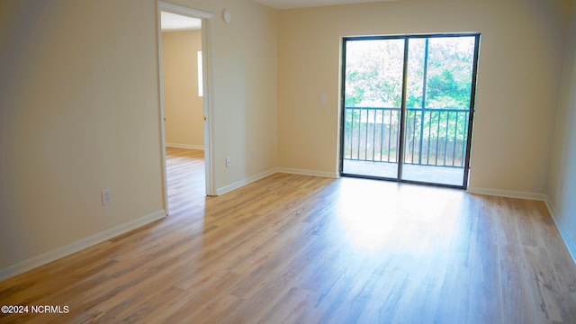 empty room featuring light wood-style floors and baseboards