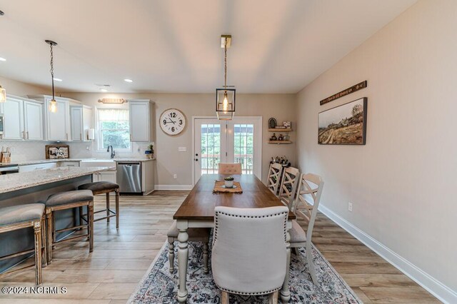 dining area featuring light hardwood / wood-style flooring and french doors