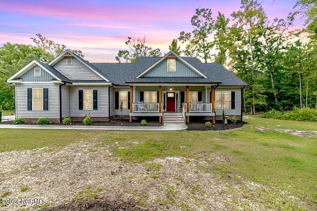 craftsman inspired home featuring a yard and a porch