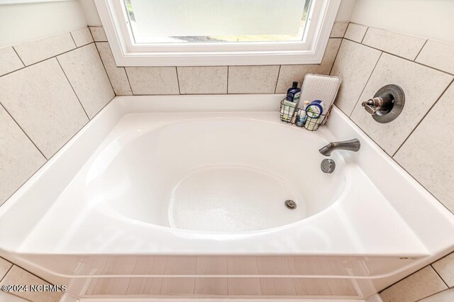 bathroom featuring tiled bath