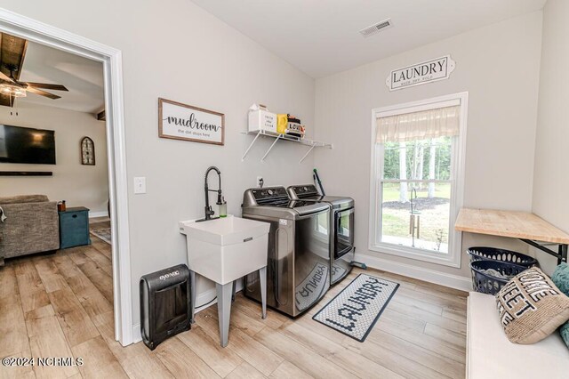 laundry area featuring ceiling fan, wood-type flooring, and washer and clothes dryer