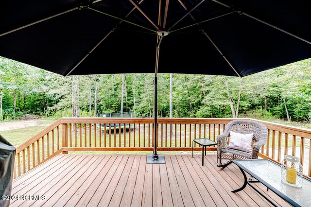 wooden deck featuring a yard