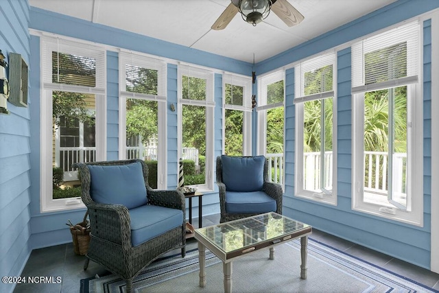 sunroom featuring a ceiling fan