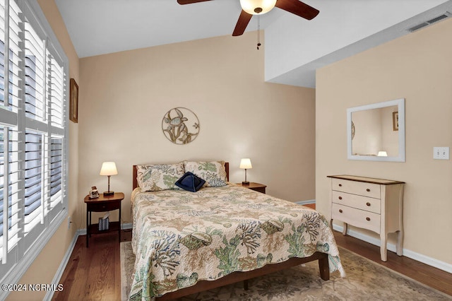 bedroom with multiple windows, vaulted ceiling, ceiling fan, and dark hardwood / wood-style floors