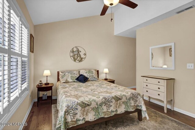 bedroom with lofted ceiling, baseboards, visible vents, and wood finished floors