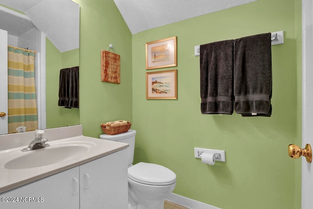 bathroom with a textured ceiling, vanity, toilet, tile patterned floors, and lofted ceiling