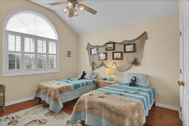 bedroom featuring lofted ceiling, ceiling fan, wood finished floors, and baseboards