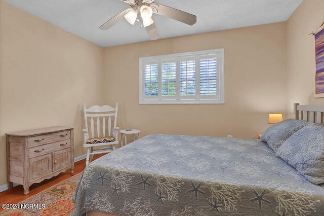 bedroom with dark wood-type flooring and ceiling fan