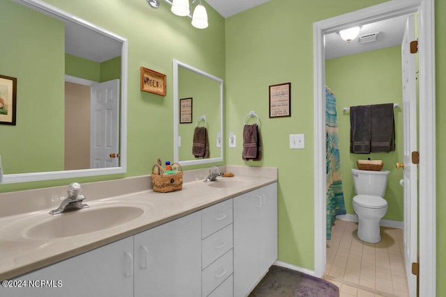 bathroom with tile patterned flooring, vanity, toilet, and curtained shower