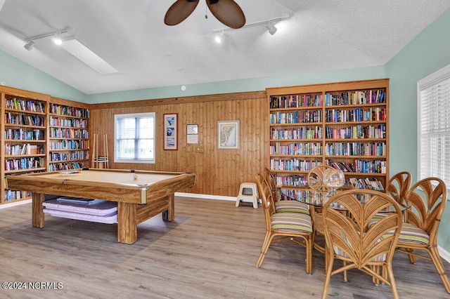 recreation room featuring billiards, vaulted ceiling, wood walls, and hardwood / wood-style floors