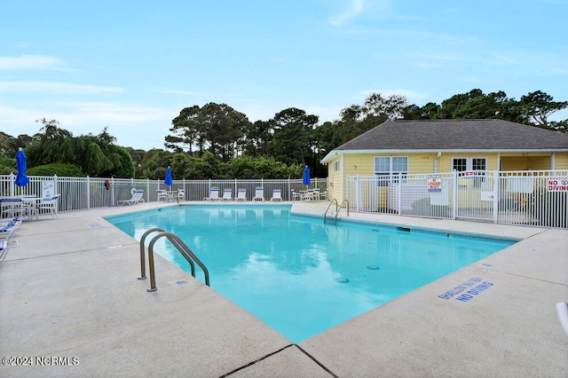 view of swimming pool with a patio