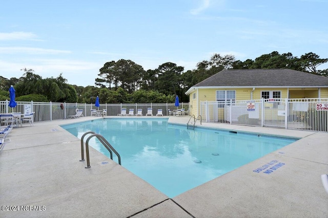 pool featuring a patio area and fence