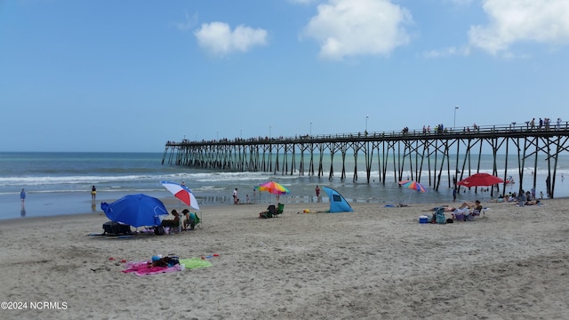 exterior space featuring a beach view and a pier