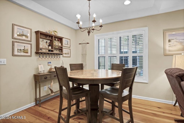 dining area with a chandelier, recessed lighting, light wood-style flooring, and baseboards