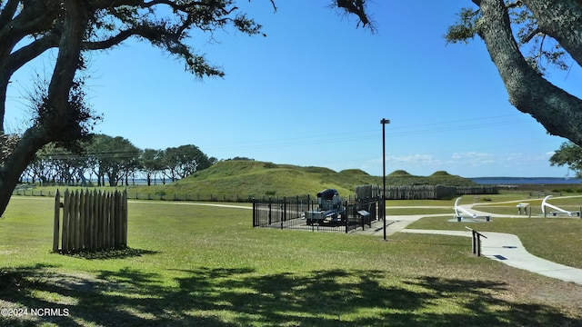 surrounding community with a yard and a mountain view