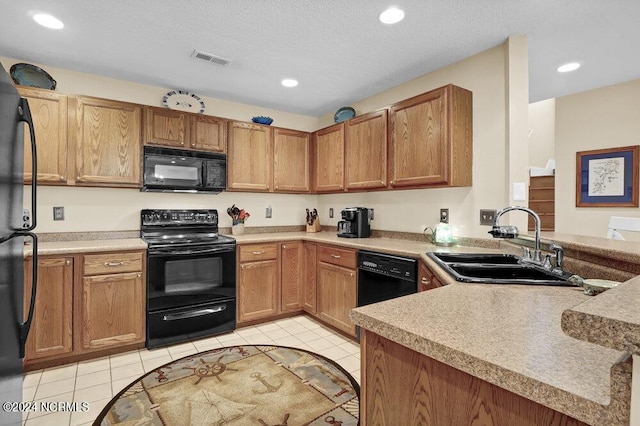 kitchen featuring black appliances, visible vents, a sink, and light tile patterned flooring