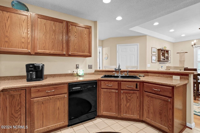 kitchen with a textured ceiling, black dishwasher, light tile patterned floors, kitchen peninsula, and sink