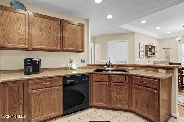 kitchen with brown cabinets, dishwasher, a peninsula, and a sink