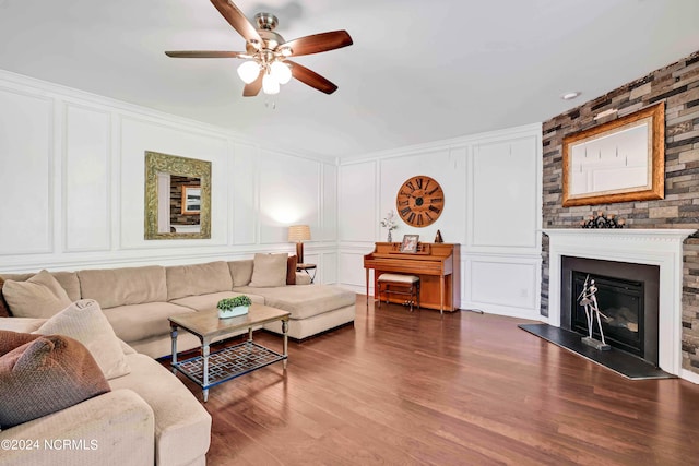 living room featuring ceiling fan and hardwood / wood-style flooring