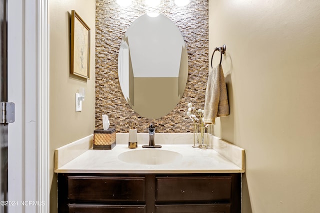 bathroom with vanity and decorative backsplash