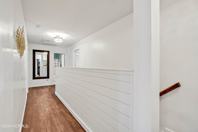 hallway with dark hardwood / wood-style flooring