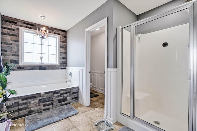 bathroom featuring separate shower and tub, a notable chandelier, and tile patterned floors