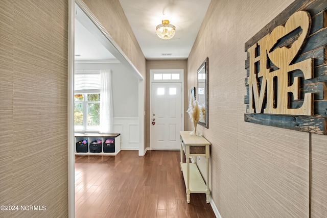 foyer featuring dark hardwood / wood-style flooring and crown molding