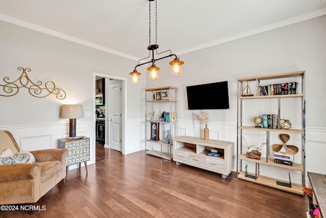 living room with ornamental molding, dark hardwood / wood-style flooring, and a notable chandelier