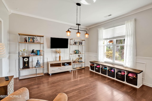 living room featuring ornamental molding, a chandelier, and dark hardwood / wood-style flooring