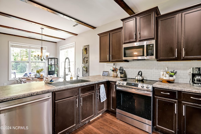 kitchen with beamed ceiling, decorative light fixtures, an inviting chandelier, sink, and appliances with stainless steel finishes