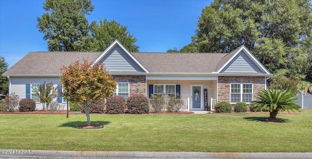 ranch-style house featuring stone siding, a front yard, and a shingled roof