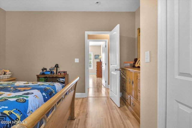 bedroom with baseboards and light wood-type flooring