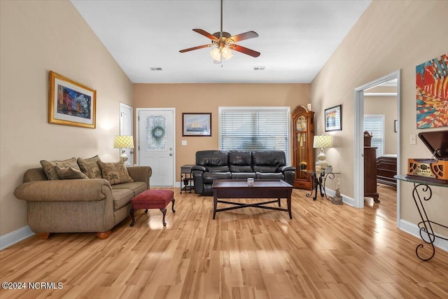 living area featuring visible vents, a healthy amount of sunlight, ceiling fan, and light wood finished floors