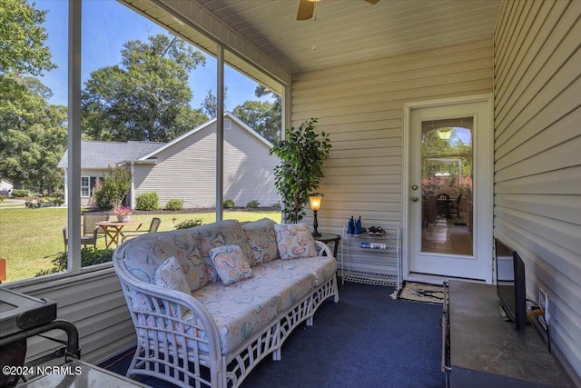 sunroom featuring wood ceiling and ceiling fan