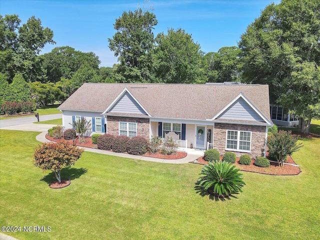 ranch-style house featuring a front yard and covered porch