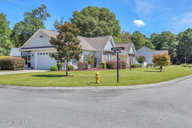 view of front of home with a garage, driveway, and a front lawn