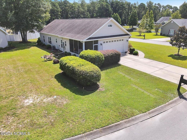 ranch-style home featuring a front lawn, an attached garage, and driveway