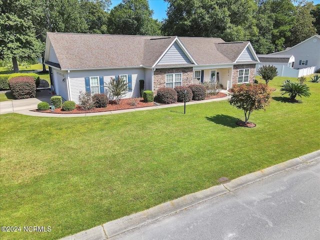 ranch-style house with stone siding, concrete driveway, a front lawn, and fence