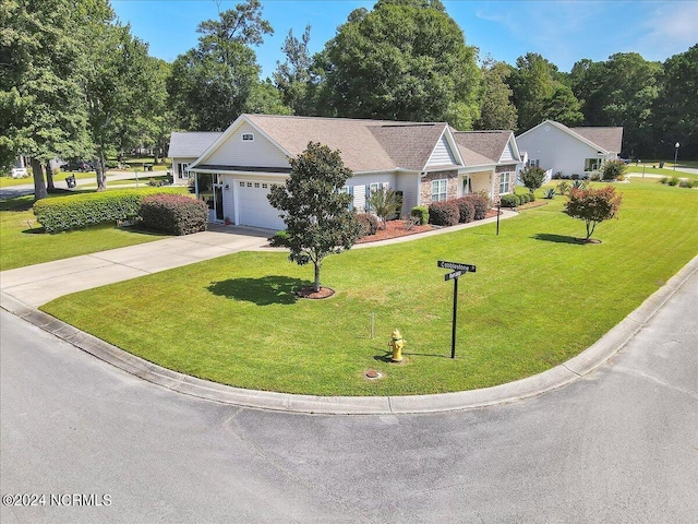 single story home with a garage, concrete driveway, and a front yard