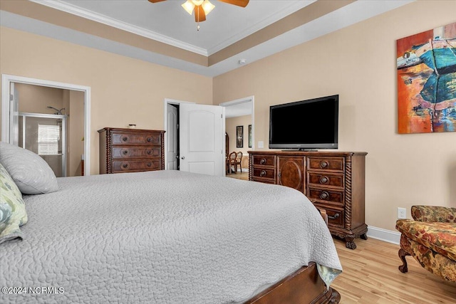 bedroom with ceiling fan, baseboards, ornamental molding, light wood-style flooring, and a raised ceiling