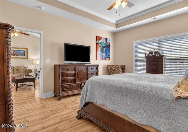 bedroom with a ceiling fan, baseboards, visible vents, ornamental molding, and light wood-type flooring