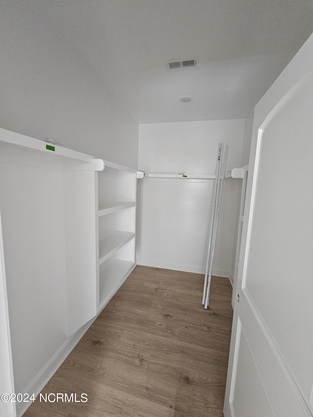 spacious closet featuring hardwood / wood-style floors