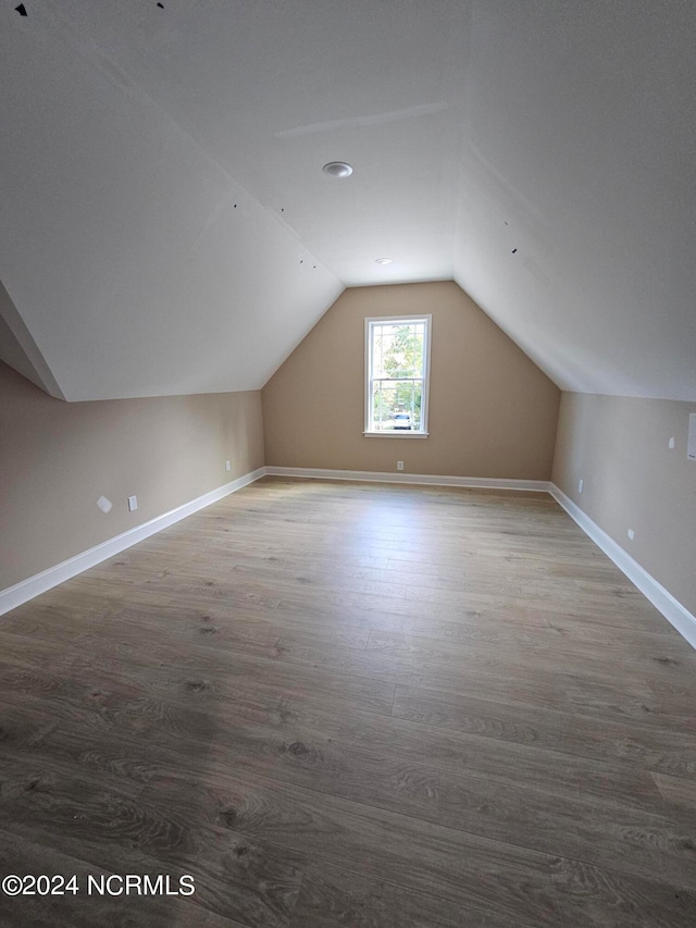 bonus room featuring hardwood / wood-style flooring and vaulted ceiling