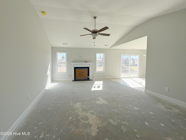 unfurnished living room featuring ceiling fan and lofted ceiling