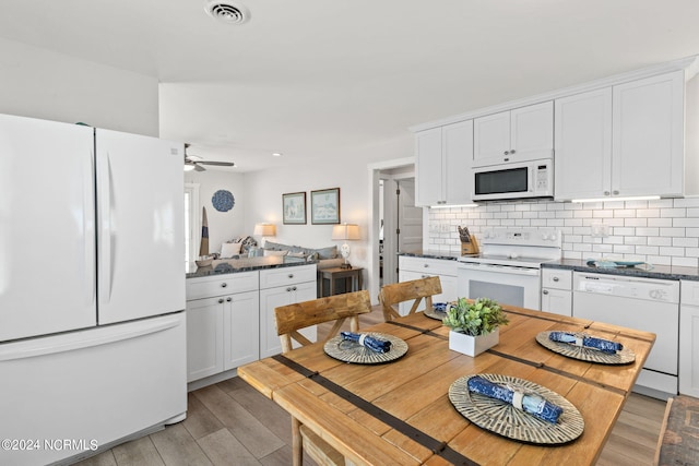 kitchen featuring white appliances, ceiling fan, white cabinetry, backsplash, and light wood-type flooring