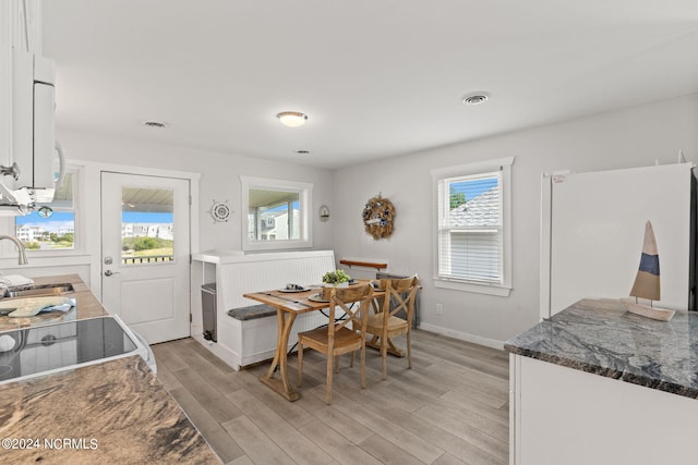 dining area featuring sink and light hardwood / wood-style floors