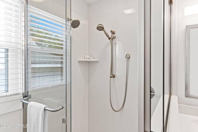 bathroom with a shower with door