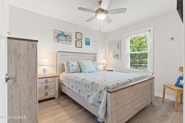 bedroom with ceiling fan and light wood-type flooring