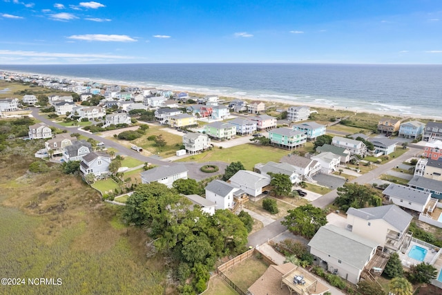 drone / aerial view featuring a water view and a beach view